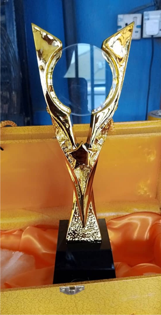 High-quality gold plaque mounted on a solid black base